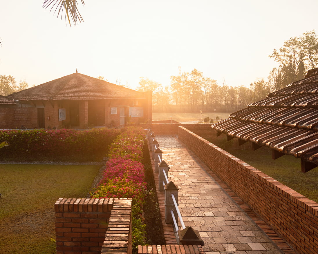 Sunset over the garden path and flower beds at Hokke Hotel