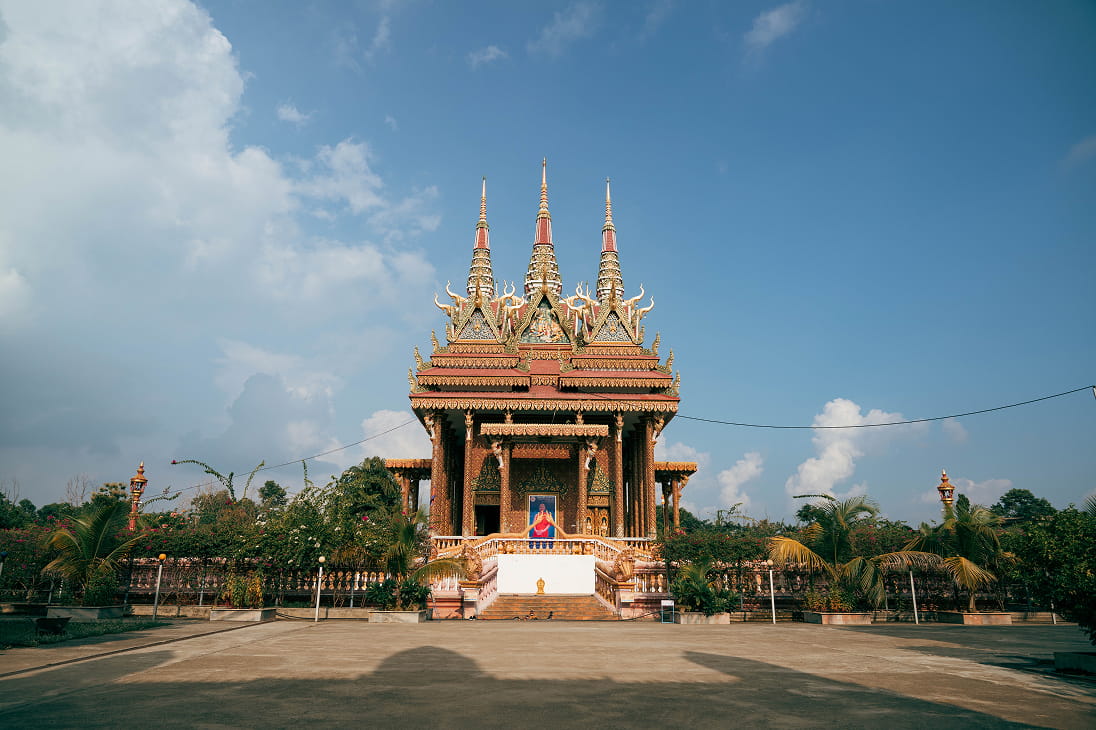 Spired Cambodian-style monastery under a blue sky in Lumbini's Monastic Zone