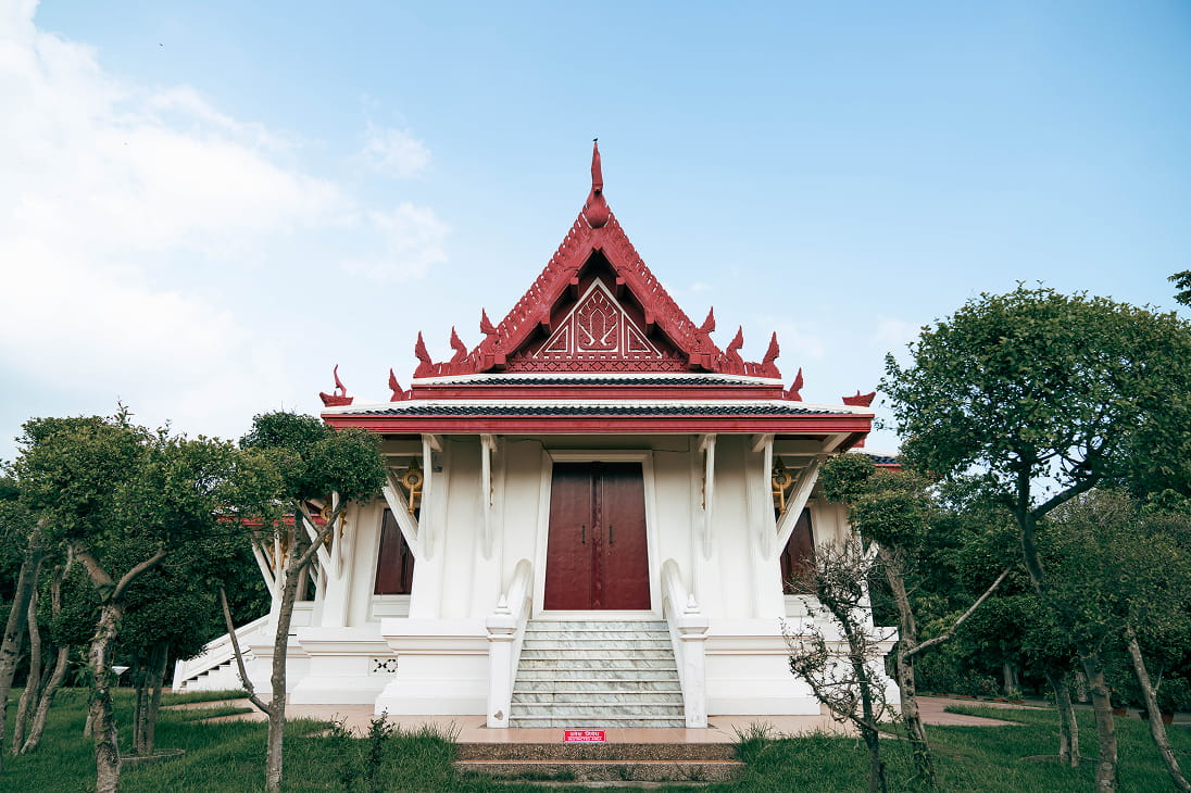 White Thai-style monastery with a red roof in Lumbini's Monastic Zone