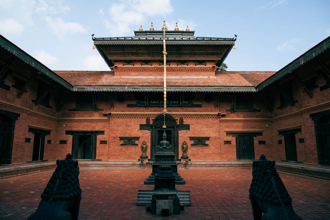 Nepali pagoda-style monastery courtyard with carved windows in Lumbini