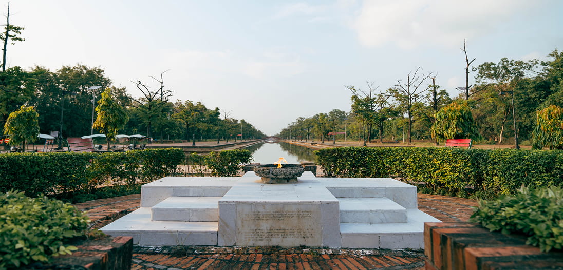 Eternal Peace Flame beside the central canal in Lumbini's Sacred Garden