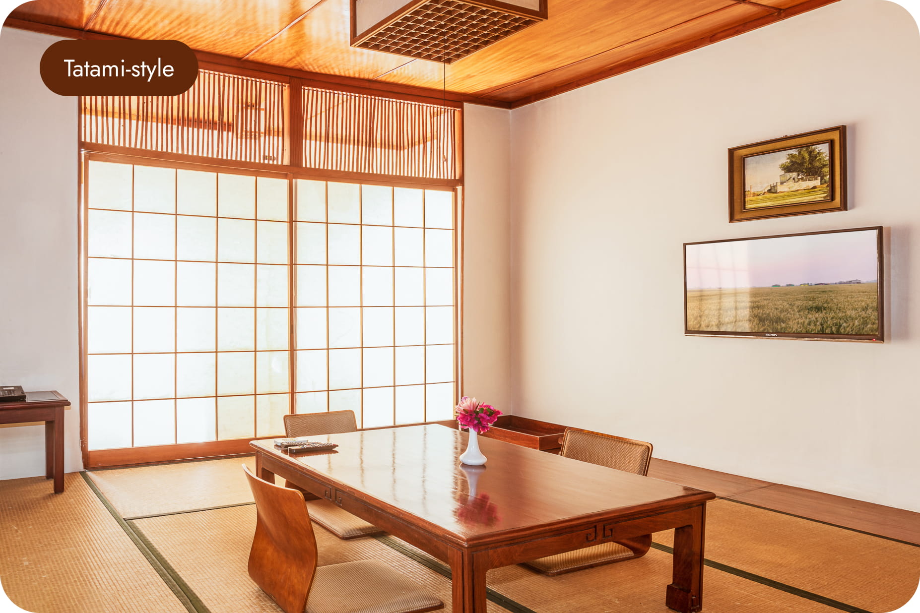 Bright tatami-style room with a low table and shoji screens at Hokke Hotel
