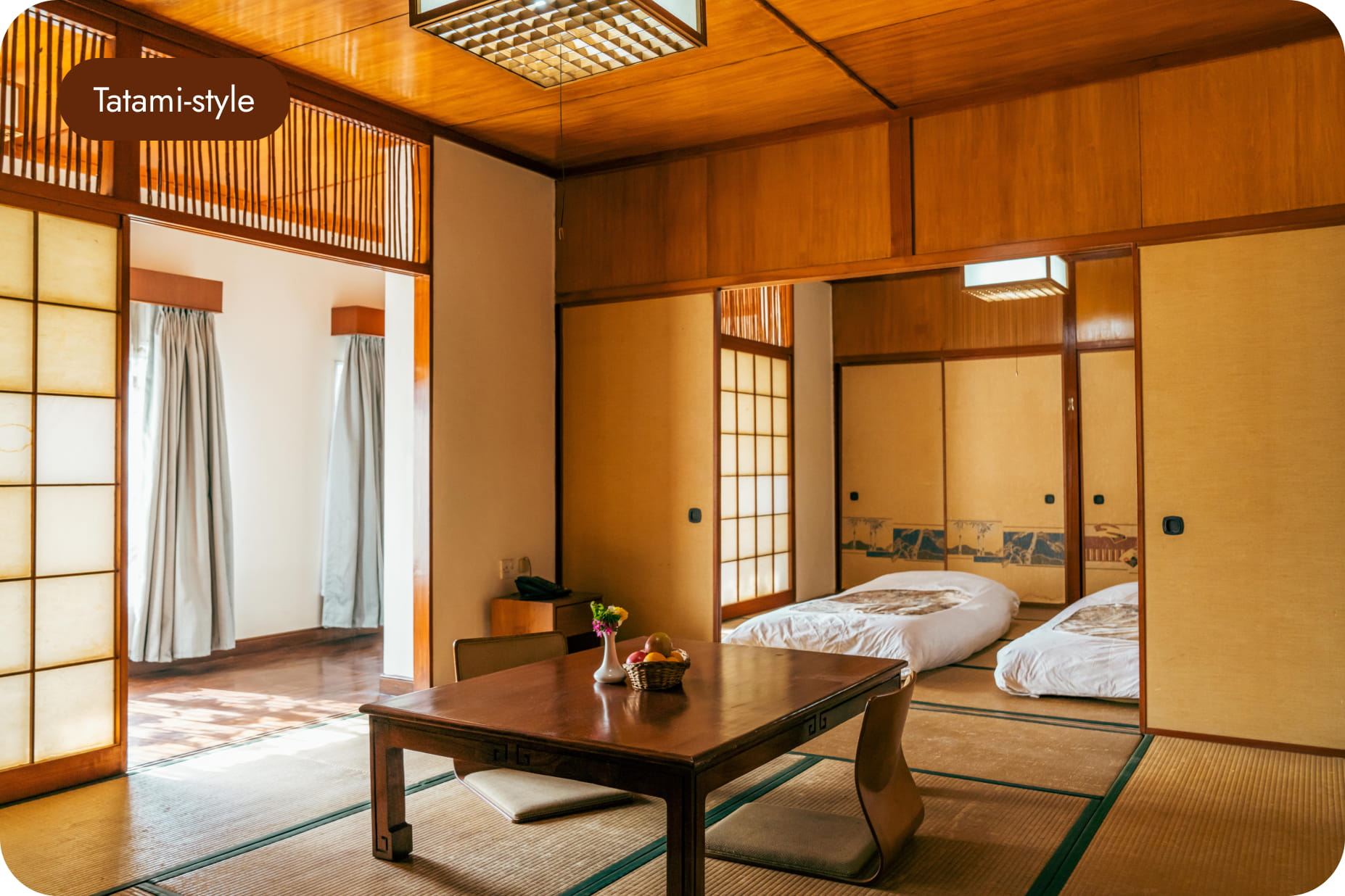 Tatami-style room with twin futons and shoji windows at Hokke Hotel