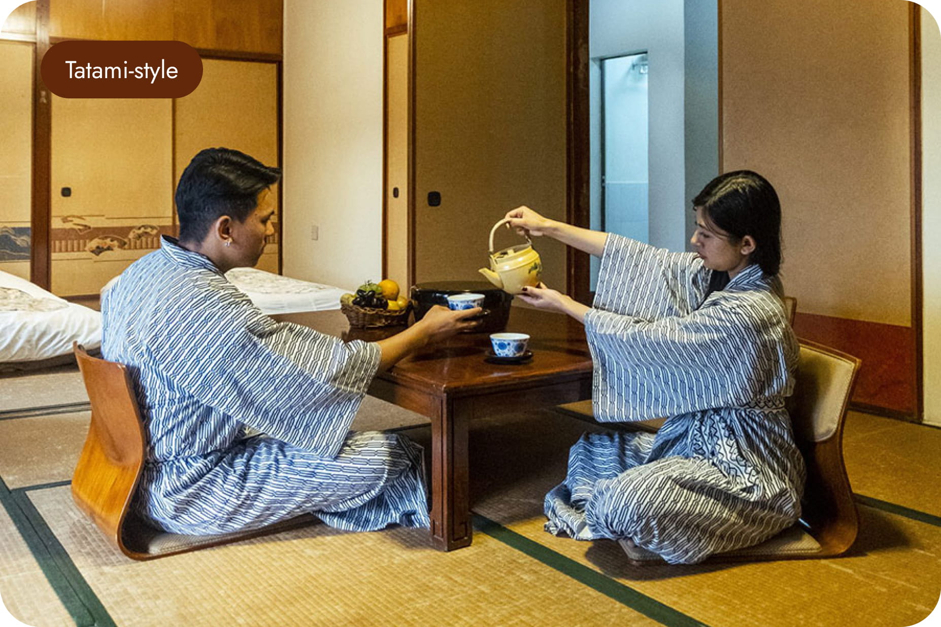 Guests in yukata pouring tea at a low table in a tatami-style room at Hokke Hotel